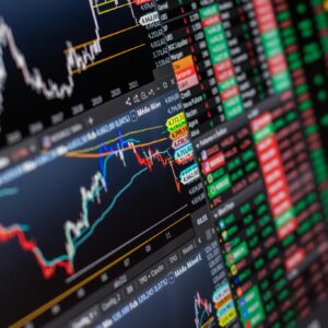 Detailed view of stock market charts and data on a monitor, showcasing market trends.